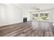 Spacious living area with hardwood floors, a fireplace, and large windows offering views of the well-maintained backyard at 411 Carlisle Dr, Indian Trail, NC 28079