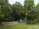 Community playground with swings, slides, and a rubberized safety surface surrounded by lush greenery for Gathering fun at 411 Carlisle Dr, Indian Trail, NC 28079