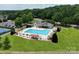 Aerial view of a community pool area with seating, shaded cabanas, and manicured landscaping for a resort-like atmosphere at 411 Carlisle Dr, Indian Trail, NC 28079