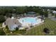 Aerial view of a community pool, featuring a unique shape, a slide, shaded areas, and ample seating for residents at 411 Carlisle Dr, Indian Trail, NC 28079