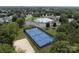 Aerial view of tennis and sand volleyball courts with surrounding trees, part of a vibrant, active community at 411 Carlisle Dr, Indian Trail, NC 28079