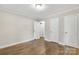 Bedroom with hardwood floors, light walls, white trim, and ample closet space at 4413 Tillman Rd, Charlotte, NC 28208