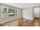 Inviting bedroom features hardwood floors and natural light from a large window at 4413 Tillman Rd, Charlotte, NC 28208