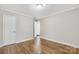 Simple bedroom featuring hardwood floors, light walls, white trim, and closet at 4413 Tillman Rd, Charlotte, NC 28208