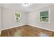 Bedroom with natural light from windows, complemented by hardwood flooring and neutral paint at 4413 Tillman Rd, Charlotte, NC 28208
