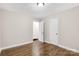Bright bedroom featuring hardwood floors, neutral walls, white trim, and a closet at 4413 Tillman Rd, Charlotte, NC 28208