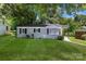 Charming single-story home with painted brick, black shutters, and a well-maintained lawn at 4413 Tillman Rd, Charlotte, NC 28208