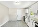 Kitchen featuring white cabinets, granite countertops, black appliances, and tile floors at 4413 Tillman Rd, Charlotte, NC 28208