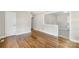 Spacious living room features hardwood floors and a view into the dining area at 4413 Tillman Rd, Charlotte, NC 28208