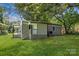 Charming single-story home with a side porch and freshly mowed lawn at 4413 Tillman Rd, Charlotte, NC 28208