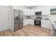 Well-equipped kitchen with white cabinets, stainless steel appliances, and granite countertops at 4472 Pebblebrook Sw Cir, Concord, NC 28027