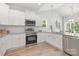 Bright kitchen featuring white cabinets, stainless steel appliances, and granite countertops at 4472 Pebblebrook Sw Cir, Concord, NC 28027