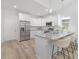 Modern kitchen with white cabinets, granite countertops, stainless steel appliances, and a breakfast bar at 4472 Pebblebrook Sw Cir, Concord, NC 28027