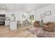 Open concept living space featuring a breakfast bar, kitchen, dining area, and cozy seating area at 4472 Pebblebrook Sw Cir, Concord, NC 28027