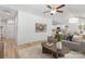 Open-concept living room with hardwood floors, a gray sofa, and views of the kitchen at 4472 Pebblebrook Sw Cir, Concord, NC 28027