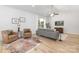 Cozy living room with a cowhide rug, comfortable seating, and a large window with natural light at 4472 Pebblebrook Sw Cir, Concord, NC 28027