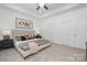 Bright main bedroom featuring a ceiling fan and large windows at 4472 Pebblebrook Sw Cir, Concord, NC 28027