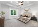 Spacious main bedroom with a tray ceiling, large window and comfortable furniture at 4472 Pebblebrook Sw Cir, Concord, NC 28027