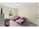 Bright bedroom with carpet, a window with natural light and two toddler beds with colorful bedding at 473 Wendover Dr, Salisbury, NC 28147