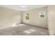 Serene bedroom with neutral carpet, two windows that provide ample natural light, and a closet at 473 Wendover Dr, Salisbury, NC 28147
