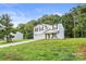 Charming two-story home with a lush green lawn, a welcoming front porch, and an attached garage at 473 Wendover Dr, Salisbury, NC 28147