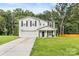 Charming two-story home featuring a well-manicured lawn, two car garage, and a welcoming front porch at 473 Wendover Dr, Salisbury, NC 28147