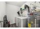 Functional laundry room with washer, dryer, water heater, overhead shelving and vinyl flooring at 473 Wendover Dr, Salisbury, NC 28147