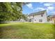 Large backyard with a white fence, lush green grass, and a screened-in porch on a white house at 4835 Chesney Nw St, Concord, NC 28027