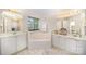 Bright bathroom featuring a soaking tub, double vanity, and tile flooring at 4835 Chesney Nw St, Concord, NC 28027