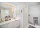 Well-lit bathroom featuring a shower with glass door and white tile at 4835 Chesney Nw St, Concord, NC 28027