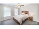 Bedroom with dark wood bed frame, patterned bedding, and a ceiling fan at 4835 Chesney Nw St, Concord, NC 28027