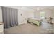 Neutral bedroom with sloped ceiling, carpet, ceiling fan, and large window at 4835 Chesney Nw St, Concord, NC 28027