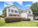 Two-story home featuring vinyl siding, black shutters, brick accents, manicured landscaping and a two-car garage at 4835 Chesney Nw St, Concord, NC 28027