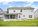 Back exterior view of a two-story house with a sunroom and patio at 4835 Chesney Nw St, Concord, NC 28027
