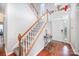 Inviting foyer with hardwood floors, staircase, large window providing natural light, and a front door at 4835 Chesney Nw St, Concord, NC 28027