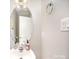 Cozy half bathroom with a pedestal sink, decorative mirror, and neutral wall color at 4835 Chesney Nw St, Concord, NC 28027