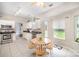 Bright kitchen featuring white cabinets, stainless steel appliances, and an adjacent eating area at 4835 Chesney Nw St, Concord, NC 28027