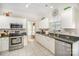 Bright kitchen features white cabinets, stainless steel appliances, granite counters, and tile flooring at 4835 Chesney Nw St, Concord, NC 28027