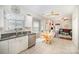 Bright kitchen with a stainless steel dishwasher, white cabinets, granite countertops, and adjacent breakfast nook at 4835 Chesney Nw St, Concord, NC 28027