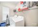 Functional laundry room with washer, dryer, shelving, and ample storage space at 4835 Chesney Nw St, Concord, NC 28027