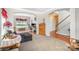 Open living room with elegant archways, plush carpeting, and a view to the staircase and adjacent room at 4835 Chesney Nw St, Concord, NC 28027