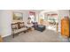 Cozy living room with plush carpeting, decorative furnishings, and bright windows at 4835 Chesney Nw St, Concord, NC 28027