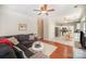 Open living room with hardwood floors, ceiling fan, and an adjoining kitchen and dining area at 4835 Chesney Nw St, Concord, NC 28027