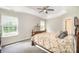 This main bedroom features an elegant tray ceiling, plush carpeting, and large windows at 4835 Chesney Nw St, Concord, NC 28027