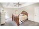 Comfortable main bedroom with tray ceilings, soft carpet, and a ceiling fan at 4835 Chesney Nw St, Concord, NC 28027