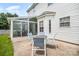 Relaxing outdoor patio area with seating, adjacent to a bright sunroom at 4835 Chesney Nw St, Concord, NC 28027
