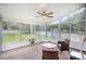 Light-filled sunroom with large windows, ceiling fan, and views of the backyard at 4835 Chesney Nw St, Concord, NC 28027