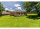 Well-maintained backyard with a deck, green lawn, and mature trees providing shade at 511 Birmingham Ct, Rock Hill, SC 29732