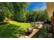 Lush backyard with a deck, mature trees, and plenty of space for outdoor activities at 511 Birmingham Ct, Rock Hill, SC 29732