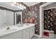 Bright bathroom featuring a double sink vanity, tile flooring, and floral wallpaper at 511 Birmingham Ct, Rock Hill, SC 29732